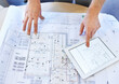 © Anne B/peopleimages.com - Going through the design with a fine-tooth comb. Shot of an architects hands examining blueprints and using a digital tablet.