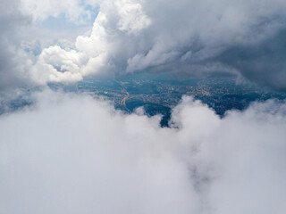 Wall Mural - Kyiv city through high clouds. Cloudy day. Aerial drone view.