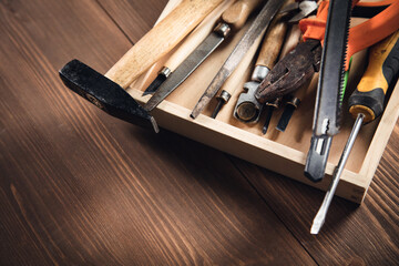 different construction tools on wooden background