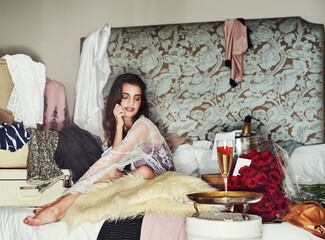 Poster - Girls have to treat themselves now and then. Shot of a beautiful young woman relaxing on her bed while being surrounded by gifts that she bought herself.