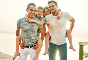 Enjoying a family outing. Cropped portrait of an affectionate mature couple carrying their kids on their shoulders outside.