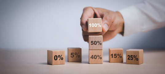 Hand chosen cube with check percent symbol printed on its one side, viewed in close-up, Interest rate financial and mortgage rates, Increasing interest rates or discount sale concept,sale and discount