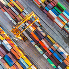 Aerial view of shipping container port terminal. Colourful pattern of containers in harbor. Maritime logistics global inport export trade transportation.