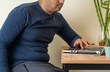 Side view photo of home office worker with fatty belly. Concept of fat or obesity due to remote work. selective focus