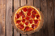 Tasty pizza with salami on wooden background