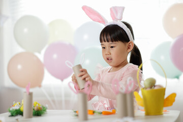 young girl making easter craft at home