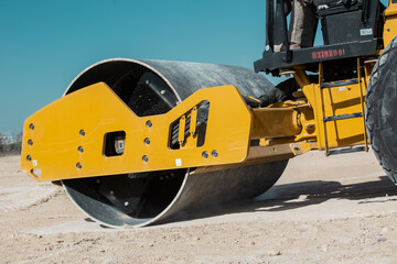 Wall Mural - Dozer, excavator, and road rollers working on the mud site