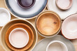 Dishes for serving and eating meals on a wooden background, top view. Modern ceramic and wooden crockery, trendy tableware, close-up.