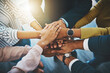 © Camerene Pendl/peopleimages.com - Together as one is how well win. Closeup shot of an unrecognizable group of businesspeople joining their hands together in a huddle.