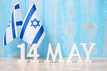 Wall Mural - Wooden text of May 14th with Israel flags. Israel Independence day and happy celebration concepts