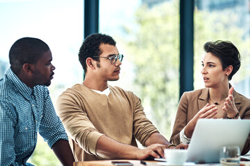 Canvas Print - Develop and sell products and services you love. Cropped shot of three designers having a brainstorming session at the office.