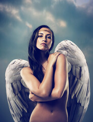 Canvas Print - Pure angelic beauty. Shot of a female angel against the sky.