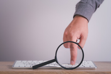 Wall Mural - magnifying glass with computer keyboard to searching for information. using search console with your