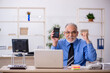 © Elnur - Old male bookkeeper working in the office