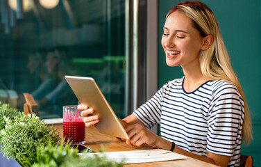 Wall Mural - Portrait og happy woman using digital tablet for work, study or social media. People technology