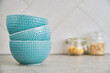 © Lazy_Bear - Three blue empty bowls on kitchen table with copy space, front view, Kitchen interior