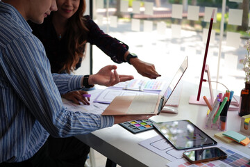 Wall Mural - creative web designer brainstorming about mobile app interface wireframe design on table at creative