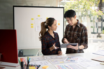 Wall Mural - team of web designers are brainstorming about mobile app interface wireframe design together.