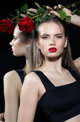 Portrait of young woman near mirror with red rose in hand. F