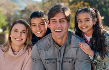 Poster - A family blooms with love. Shot of a happy young enjoying spending time together in the park.