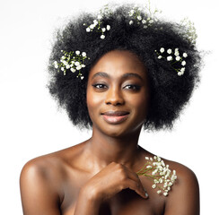 Wall Mural - Happy African Beauty Model Face Portrait with White Flower in Afro Hair Style. Woman with Black Hair enjoying Body Skin Care Spa Cosmetics over Isolated White Background