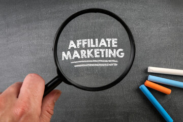 Canvas Print - Affiliate Marketing. Magnifying glass and colored pieces of chalk on a blackboard