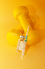 Poster - syringe and a jar of liquid lie on dumbbells on a yellow background, a vertical picture. the concept of doping in sports, steroids, testosterone and other drugs banned in sports.