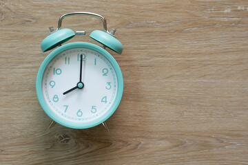 Wall Mural - Retro green alarm clock on wooden table, vintage style