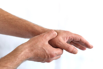 Man holding hand with thumb pain problem point out hurt area with red gradient color, isolated on white with copy space for text.