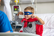 © Rido - Strong boy in superhero costume at hospital