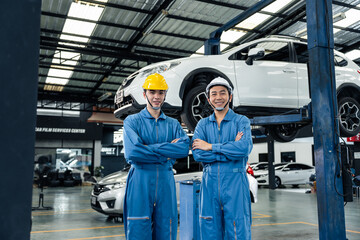 Portrait of Asian two handsome automotive mechanic men stand in garage