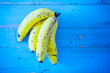 Yellow fresh and bio banana fruits on a blue wooden background Studio banana composition. Vitamin and healthy lifestyle nutrition food concept