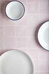 Wall Mural - white empty plates kitchen pink tile background, ceramic. place for text.