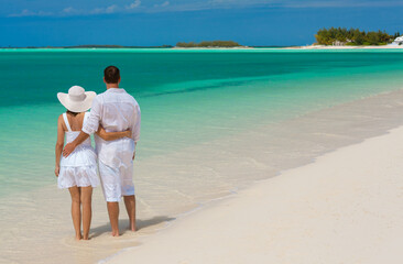 Wall Mural - Loving Caucasian couple carefree on beach holiday Caribbean