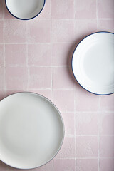 Wall Mural - white empty plates kitchen pink tile background, ceramic. place for text.