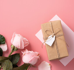 mother's day design concept background with pink rose flower and gift on pink background.