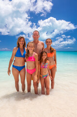 Wall Mural - Portrait of Caucasian family on beach enjoying leisure