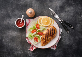 Wall Mural - Fried chicken breast. Grilled chicken breast with vegetable salad and lemon