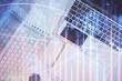 © peshkova - Financial market graph and top view computer on the desktop background. Multi exposure. Investment concept.