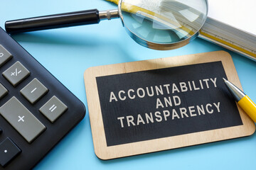a sign with an inscription accountability and transparency and a magnifying glass.