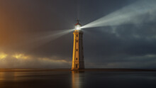 Lighthouse At Sunset With Light Rays