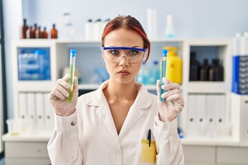 Canvas Print - Young caucasian woman working at scientist laboratory holding samples skeptic and nervous, frowning upset because of problem. negative person.