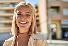 Young Blonde Girl Smiling Happy Standing At The City.