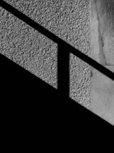 Grayscale Photo Of Trail Shadows On Wall