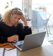 © Scopio - Mature woman working from home with her laptop