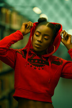 Portrait of woman in red crop-top hoodie in focus