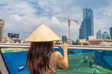 sightseeing tour buses in ho chi minh city, vietnam. hop on hop off tourist bus and vietnamese women