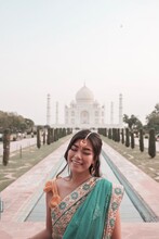 Smiling Woman Standing Near Taj Mahal