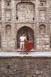 © Scopio - Woman in red dress hugging a man in Agrasen Ki Baoli historical step well in New Delhi, India