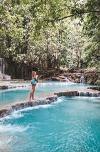 Woman Standing At Kuang Si Waterfalls In Laos